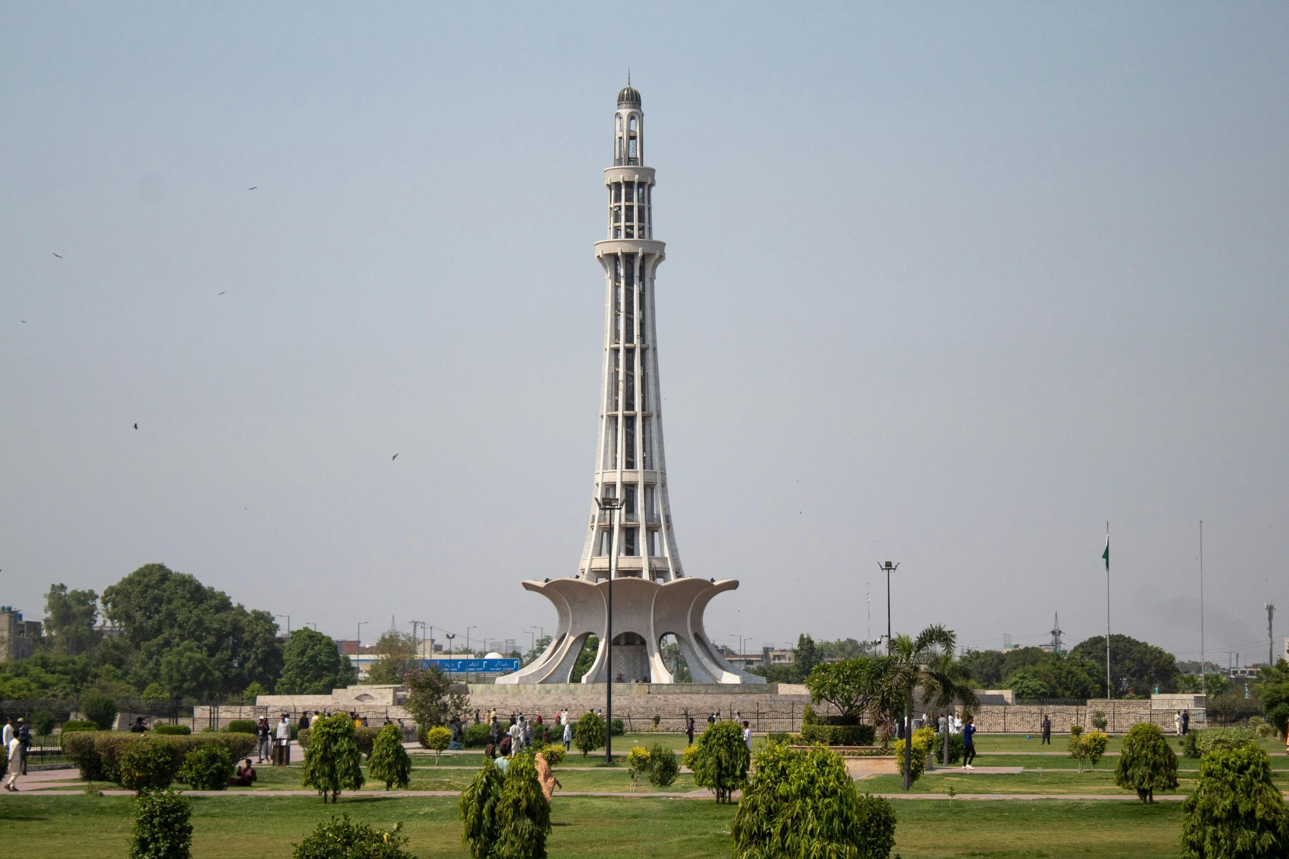 Stunning daytime capture of Minar-e-Pakistan surrounded by lush greenery in Lahore.